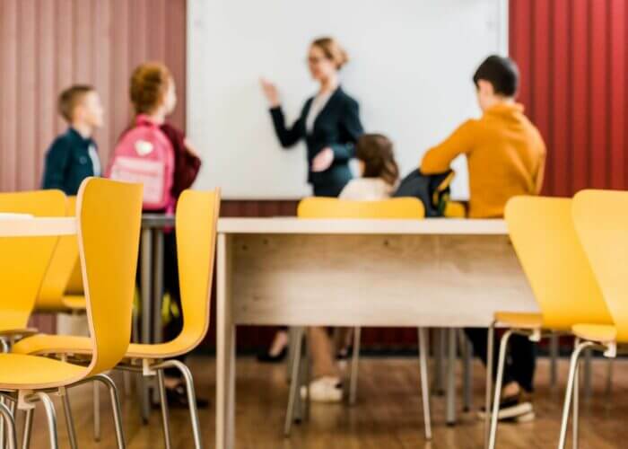 Teacher and children in a classroom environment