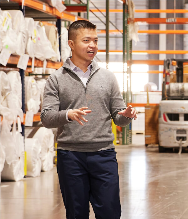 Ray Wang in conversation in a warehouse of Rasa Floors