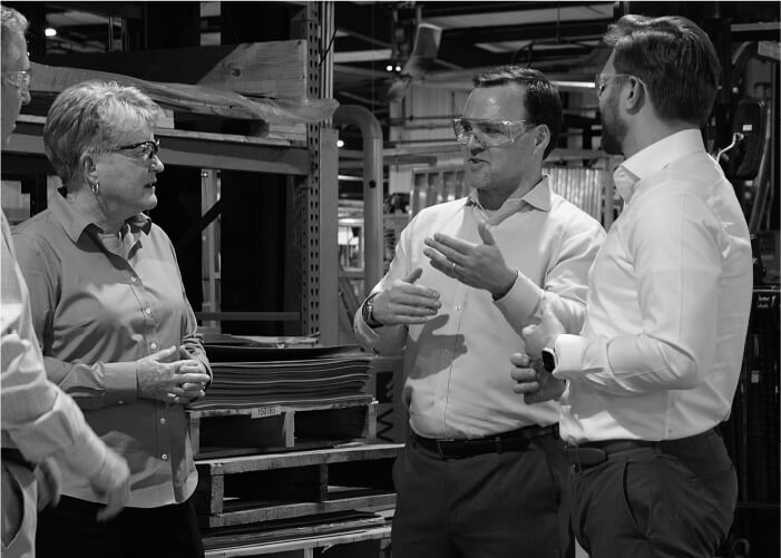 Southern Aluminum CEO Allison Schultz converses with Scott VandekerKerkhoff and Casey Yuhas of Saw Mill