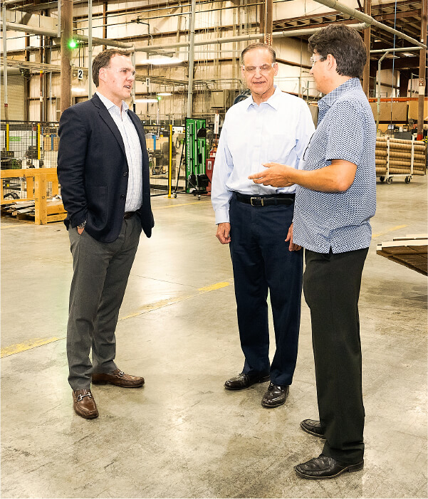 Conversation on the warehouse floor at Versatrim